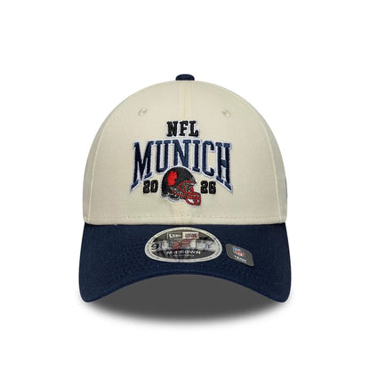 Pictured is this NFL International Series Games 2026 Munich New England Patriots 9FORTY M-Crown cap in white & dark blue. 2