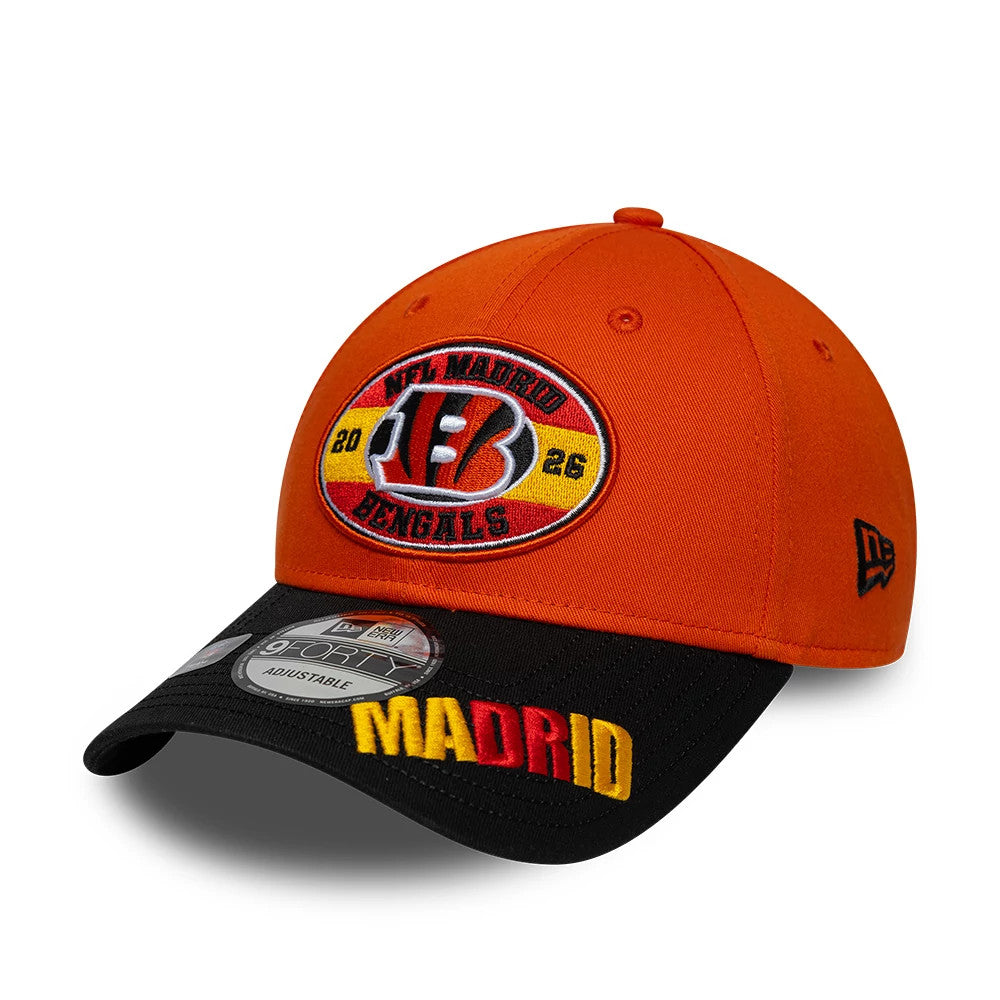 Bengals NFL International Games 2026 Madrid Orange & Black New Era 9FORTY Adjustable Cap, front view showing the colourful NFL Madrid Bengals emblem on the orange crown, black visor with yellow and red Madrid embroidery and 9FORTY size sticker.