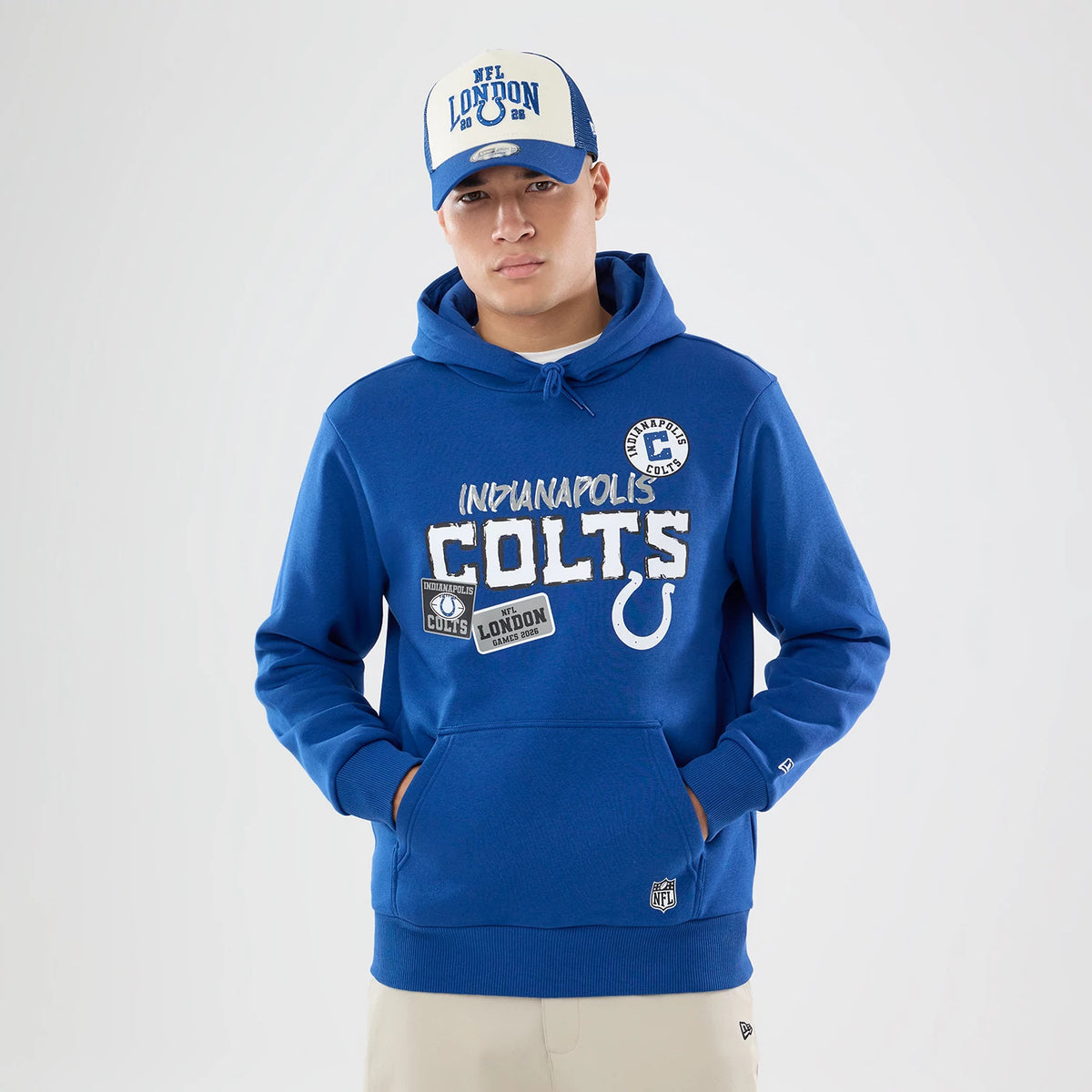 The model is wearing this NFL International Series Games 2026 Indianapolis Colts Pullover Hoodie in blue. 1