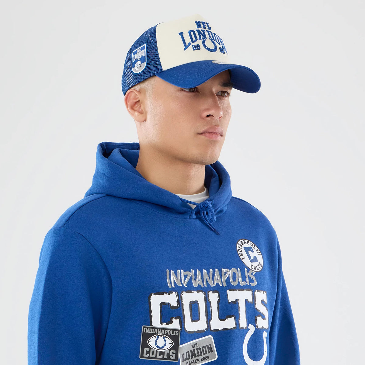 The model is wearing this NFL International Series Games 2026 Indianapolis Colts Pullover Hoodie in blue. 6