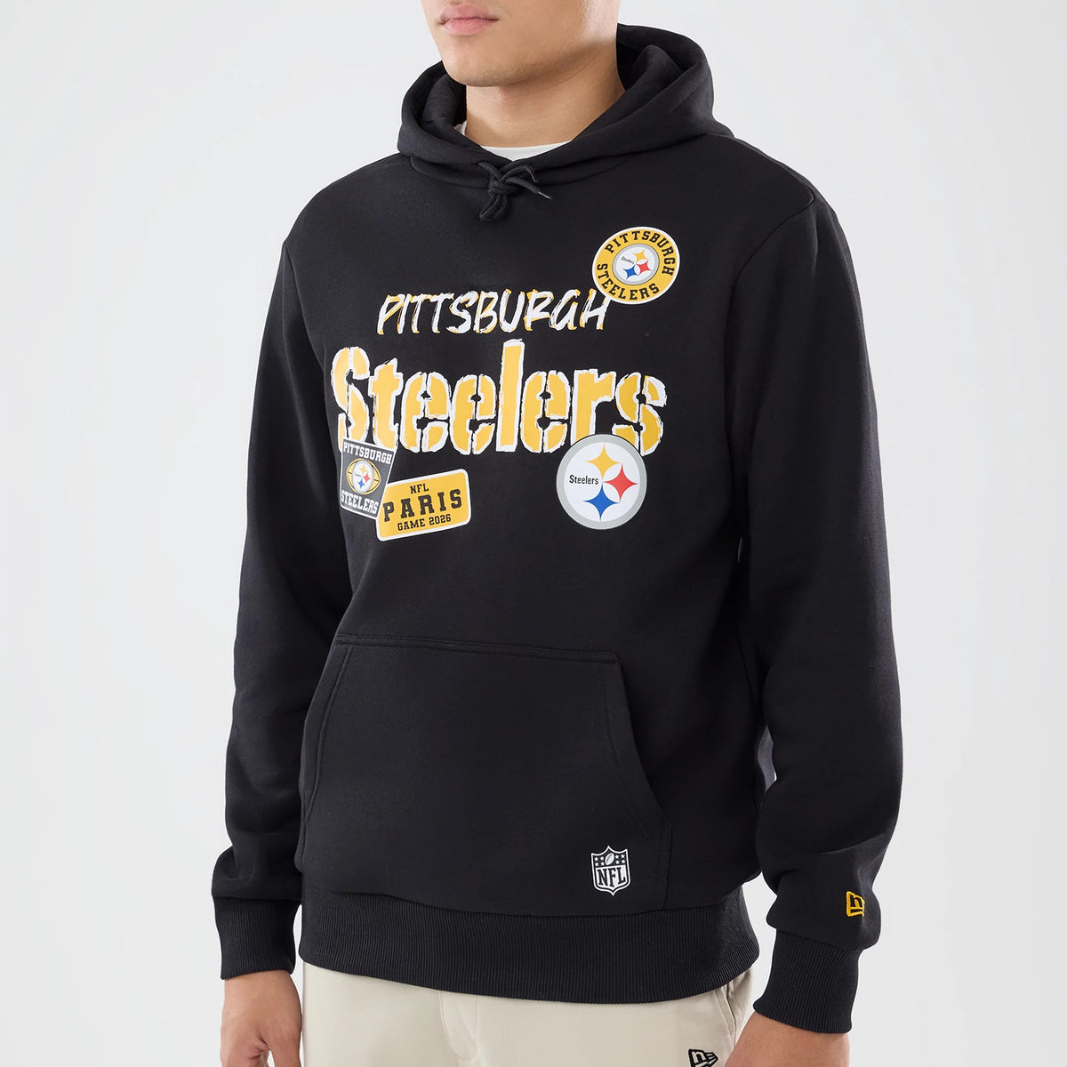 The model is wearing this NFL International Series Games 2026 Pittsburgh Steelers Pullover Hoodie in black. 3