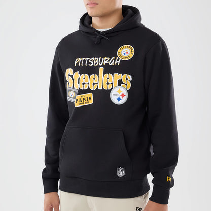 The model is wearing this NFL International Series Games 2026 Pittsburgh Steelers Pullover Hoodie in black. 3