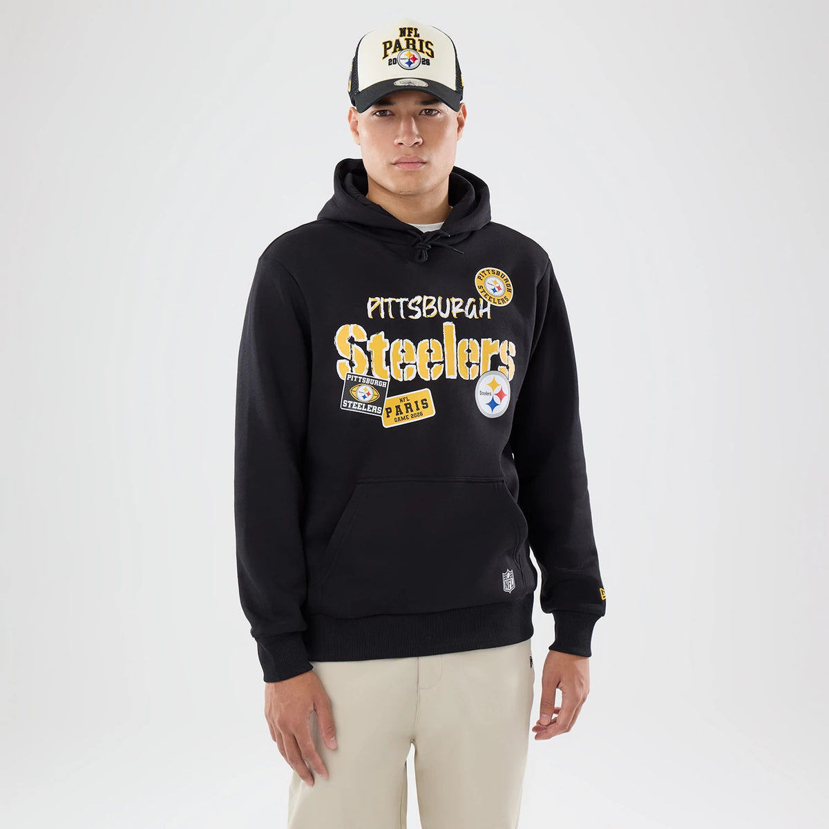 The model is wearing this NFL International Series Games 2026 Pittsburgh Steelers Pullover Hoodie in black. 1