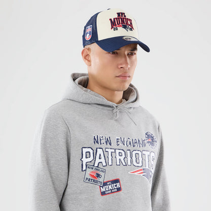The model is wearing this NFL International Series Games 2026 New England Patriots Pullover Hoodie in grey. 6