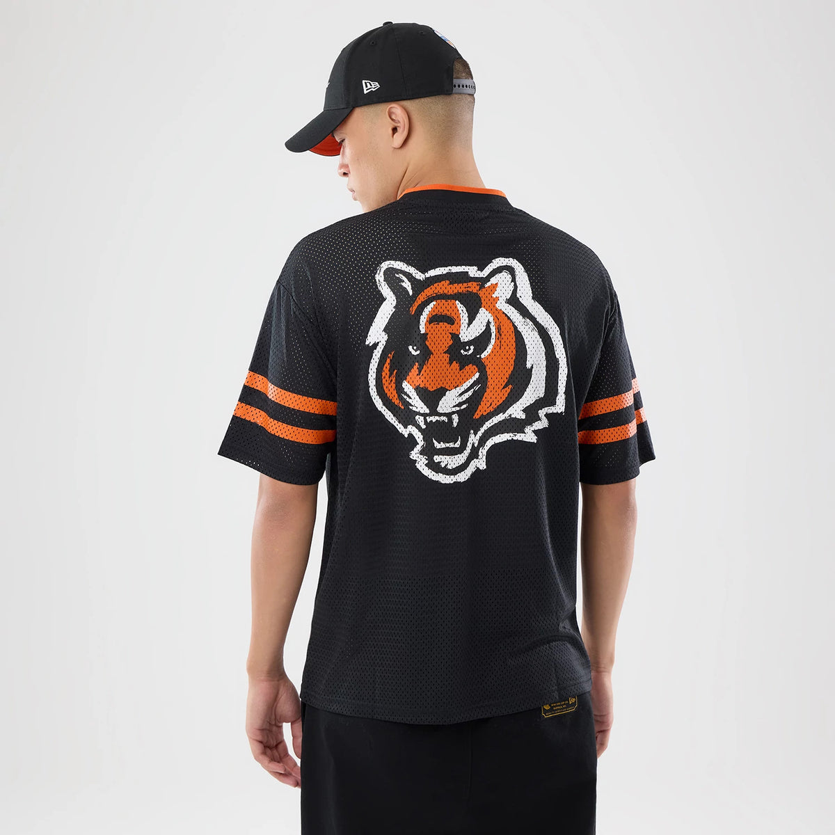 The model is wearing this NFL International Series Games 2026 Cincinnati Bengals Mesh Jersey in black. 2