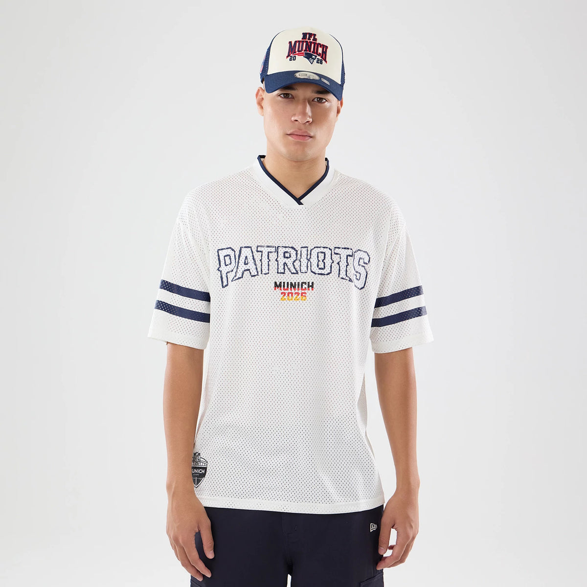The model is wearing this NFL International Series Games 2026 New England Patriots Mesh Jersey in white. 1