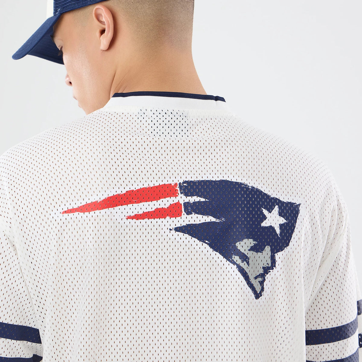 The model is wearing this NFL International Series Games 2026 New England Patriots Mesh Jersey in white. 7