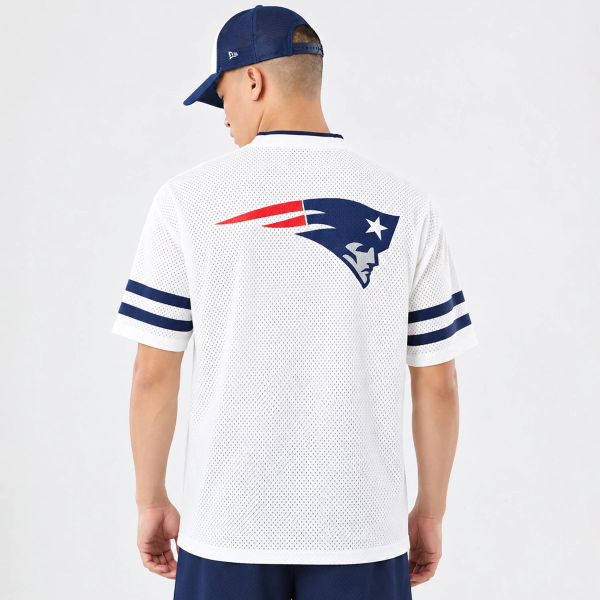 The model is wearing this NFL International Series Games 2026 New England Patriots Mesh Jersey in white. 2