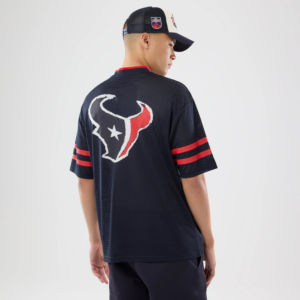 The model is wearing this NFL International Series Games 2026 Houston Texans Mesh Jersey in navy. 2