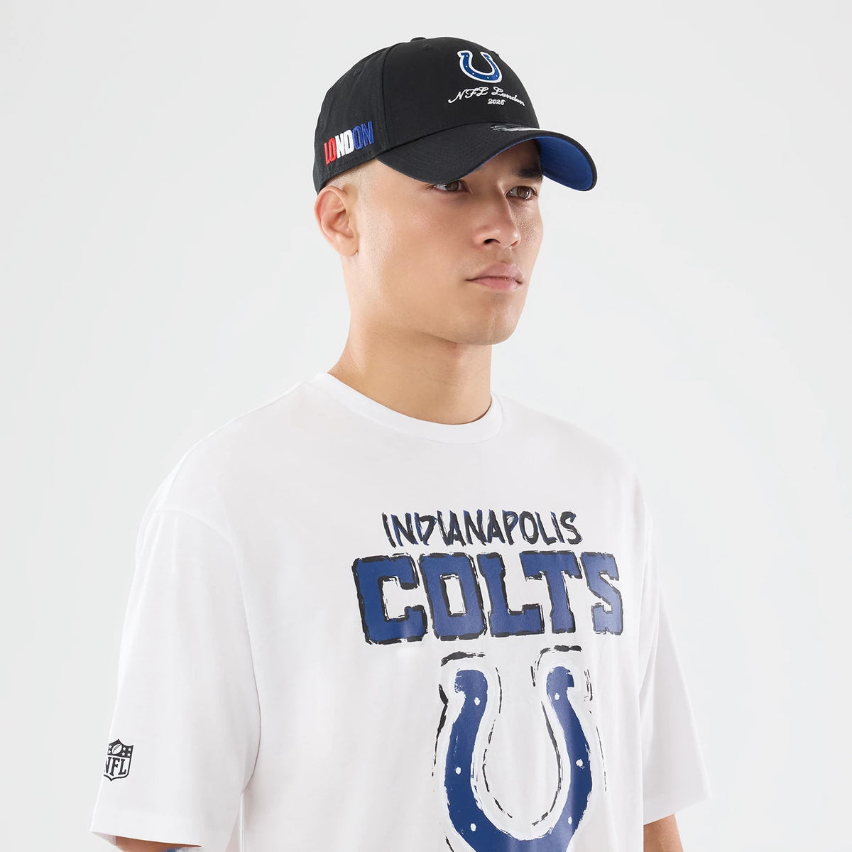 The model is wearing this NFL International Series Games 2026 Indianapolis Colts Oversized T-Shirt in white. 6