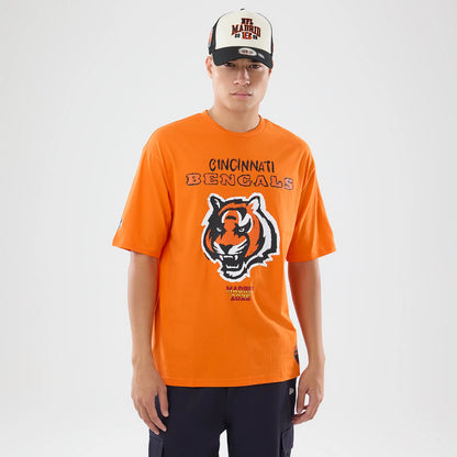 The model is wearing this NFL International Series Games 2026 Cincinnati Bengals Oversized T-Shirt in orange. 1