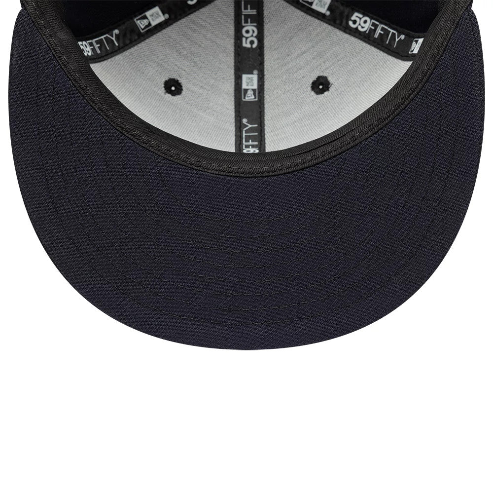 New Era Navy 59FIFTY Fitted Cap, inside view showing the grey undervisor and the black internal sweatband with New Era and 59FIFTY logos on the taping, along with black eyelets contrasting against the light interior fabric.