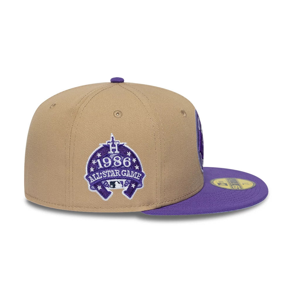 Houston Astros MLB Cooperstown Beige New Era 59FIFTY Fitted Cap, side view showing a purple 1986 All-Star Game logo embroidered on the beige crown, a matching purple top button, and the visor with a gold 59FIFTY size sticker.