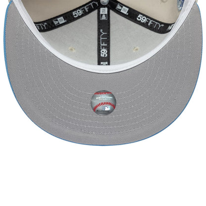 Colorado Rockies MLB Cooperstown Cream New Era 59FIFTY Fitted Cap, inside view showing the grey undervisor with detailed stitching, MLB holographic sticker centred, and black taping with 59FIFTY marking running along the seams.