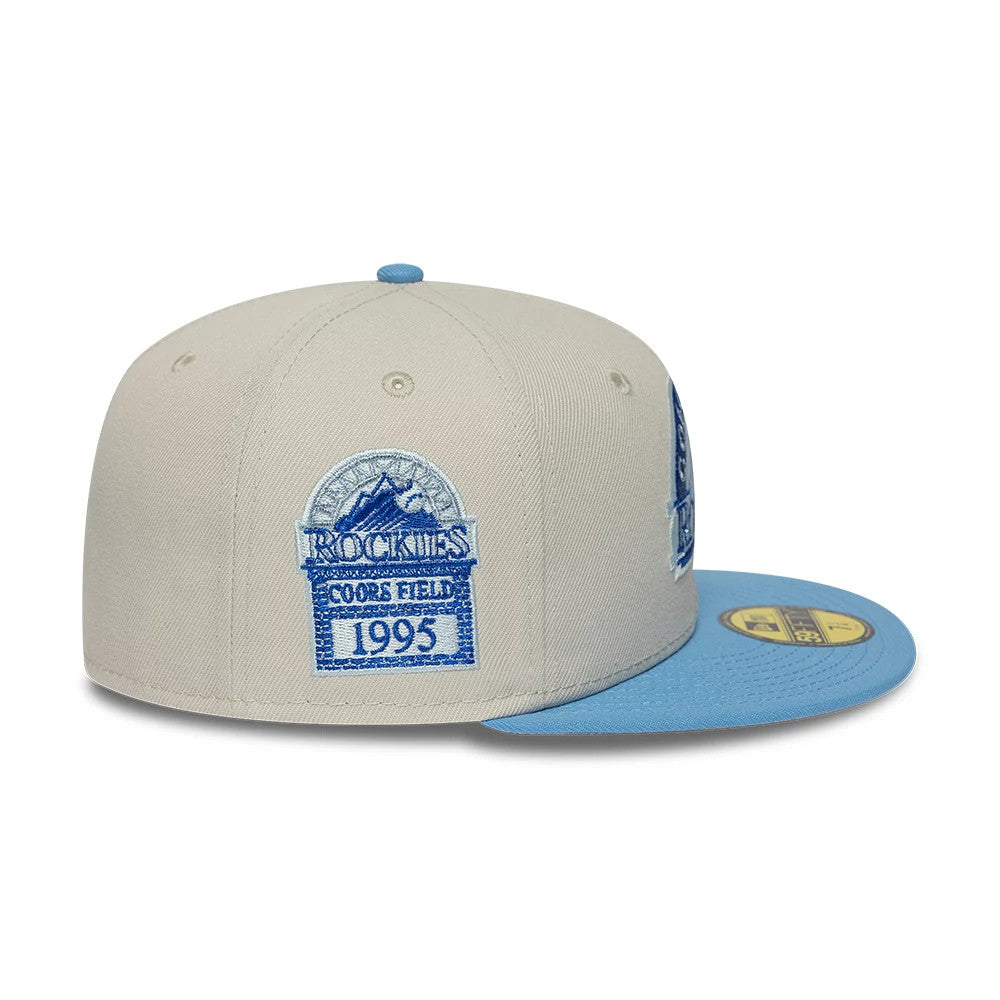 Colorado Rockies MLB Cooperstown Cream New Era 59FIFTY Fitted Cap, side view showing a light blue and white embroidered Rockies Coors Field 1995 logo on the cream mid panels, with a flat light blue visor and a gold 59FIFTY size sticker.