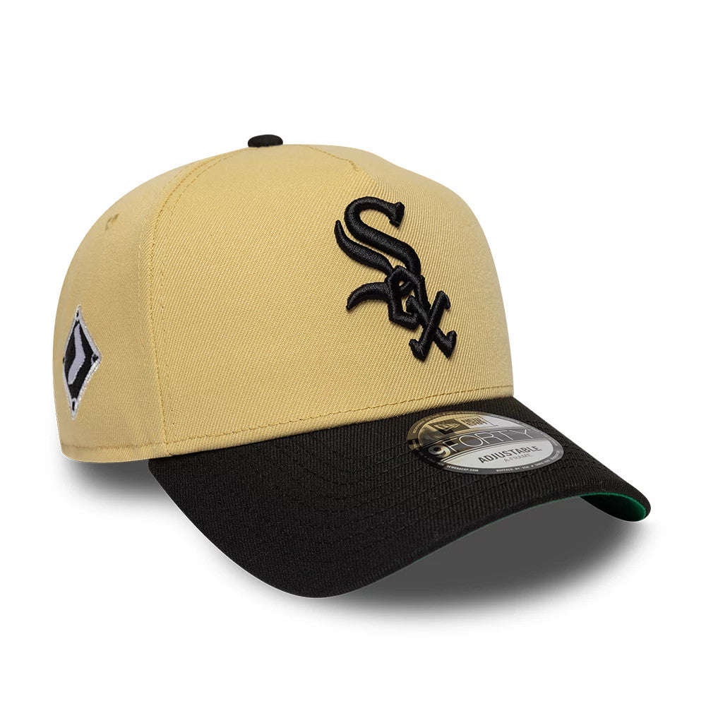 Chicago White Sox MLB Vegas Gold New Era 9FORTY A-Frame Cap, three-quarter view showing the raised black embroidered Sox logo on the front panel, a black visor with a 9FORTY size sticker, and the green undervisor edge peeking out.