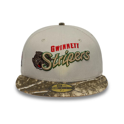 Gwinnett Stripers MiLB Hometown Sidepatch Beige New Era 59FIFTY Fitted Cap, front view showing the raised team logo embroidery with red and green accents on the beige crown, a camo-patterned visor, and a gold 59FIFTY size sticker.