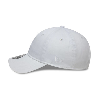 New Era White 9TWENTY Adjustable Cap, side view showing the white embroidered New Era flag logo on the left side, a white structured crown with matching eyelets, and a curved white visor with a 9TWENTY size sticker.