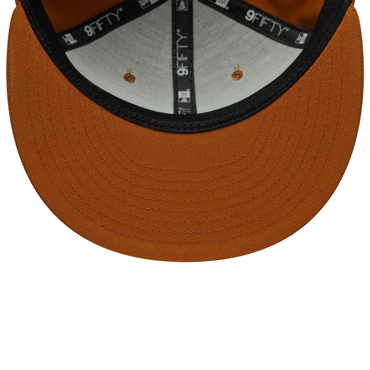 New Era Brown 9FIFTY Snapback Adjustable Cap, inside view showing black and grey taping with white 9FIFTY branding, a soft grey sweatband, and a solid brown undervisor, along with matching brown stitched eyelets.