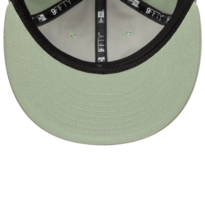 New Era Green Retro Crown 9FIFTY Snapback Adjustable Cap, inside view showing a mint green undervisor with detailed stitching, black taping with white 9FIFTY branding throughout, and green eyelets on the inner panels of the structured crown.