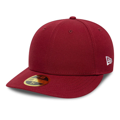 New Era Dark Red Low Profile 59FIFTY Fitted Cap, three-quarter view showing the white embroidered New Era flag logo on the left side, a gold 59FIFTY size sticker on the flat dark red visor and a matching top button.