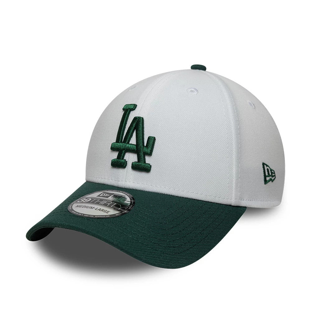 LA Dodgers MLB White New Era 39THIRTY Stretch Fit Cap, three-quarter view showing the green embroidered LA logo on the white front panel, with a dark green curved visor and 39THIRTY size sticker, plus New Era flag logo on the left side.