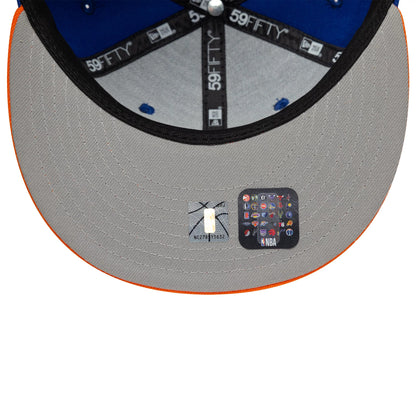 Pictured is this NBA Champs 2025 - 2026 New York Knicks 59FIFTY Fitted cap in blue and orange. 2