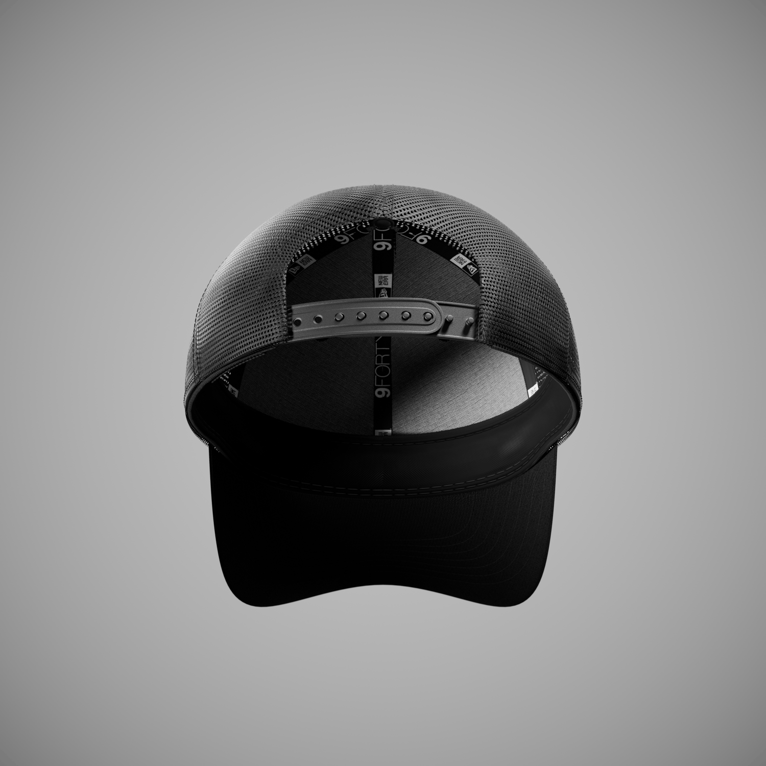 Black cap with mesh back on a gray background