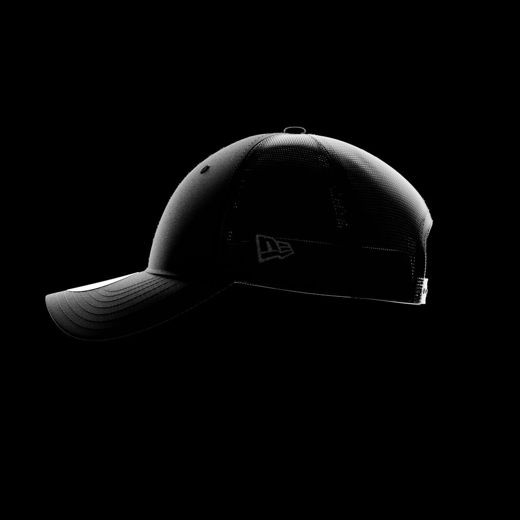 A black 9FORTY cap with a mesh back shown in side profile against a solid black background, featuring a subtle tonal New Era Flag on the side and a structured curved brim.