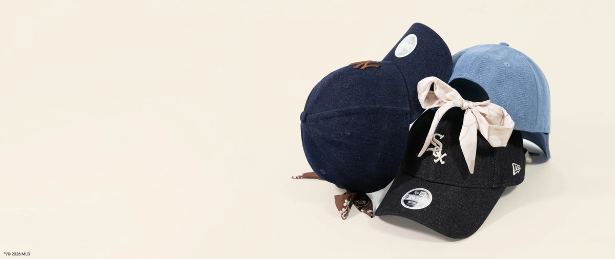 Three baseball caps in denim in different colors on a light background