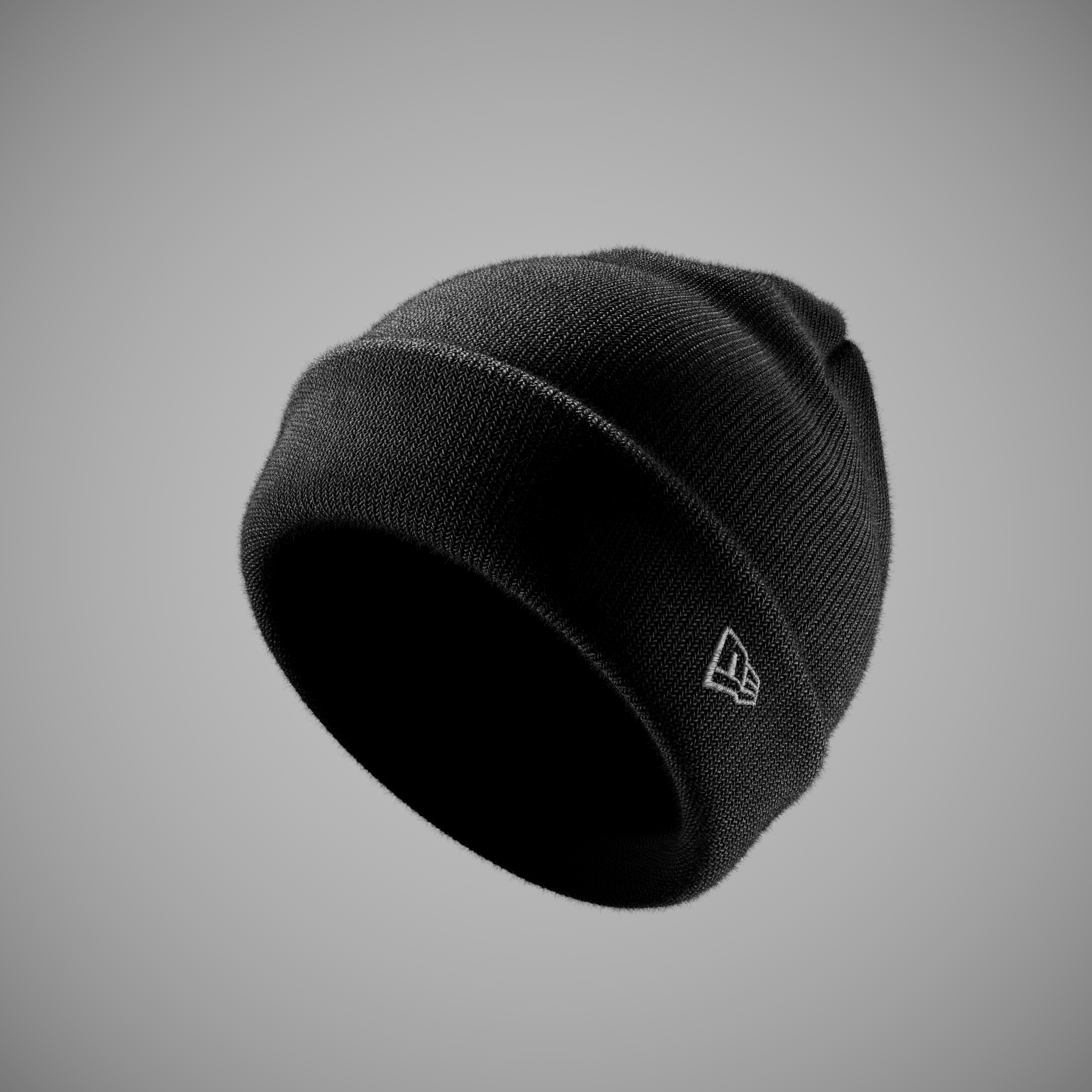 Black new era beanie with a logo on a gray background