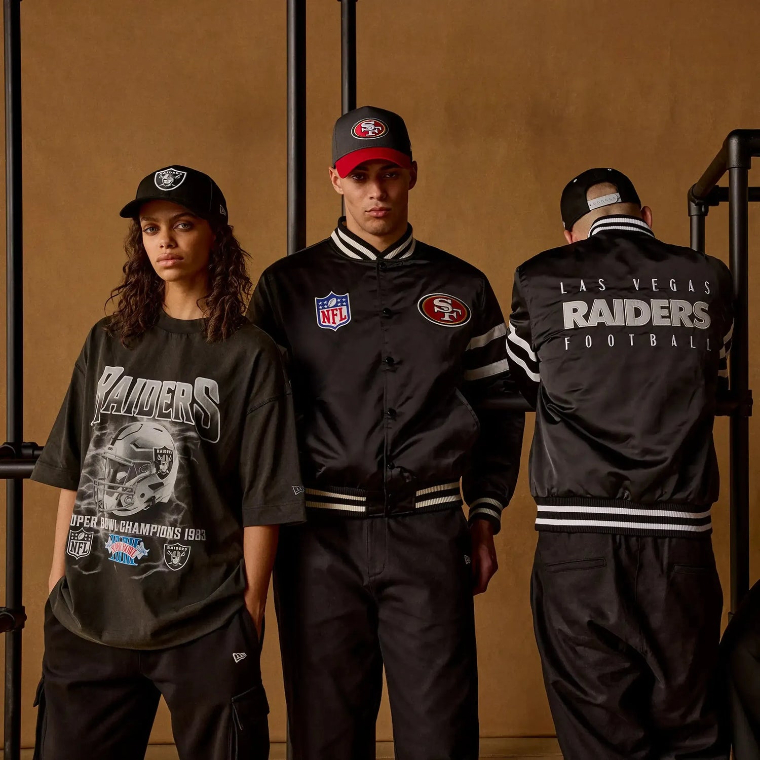 three people wearing new era NFL caps and clothing