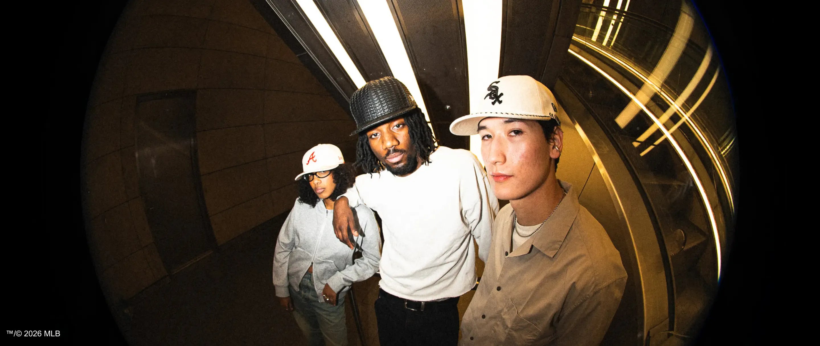 Three people posing together in a circular mirror reflection wearing new era 59fifty caps.