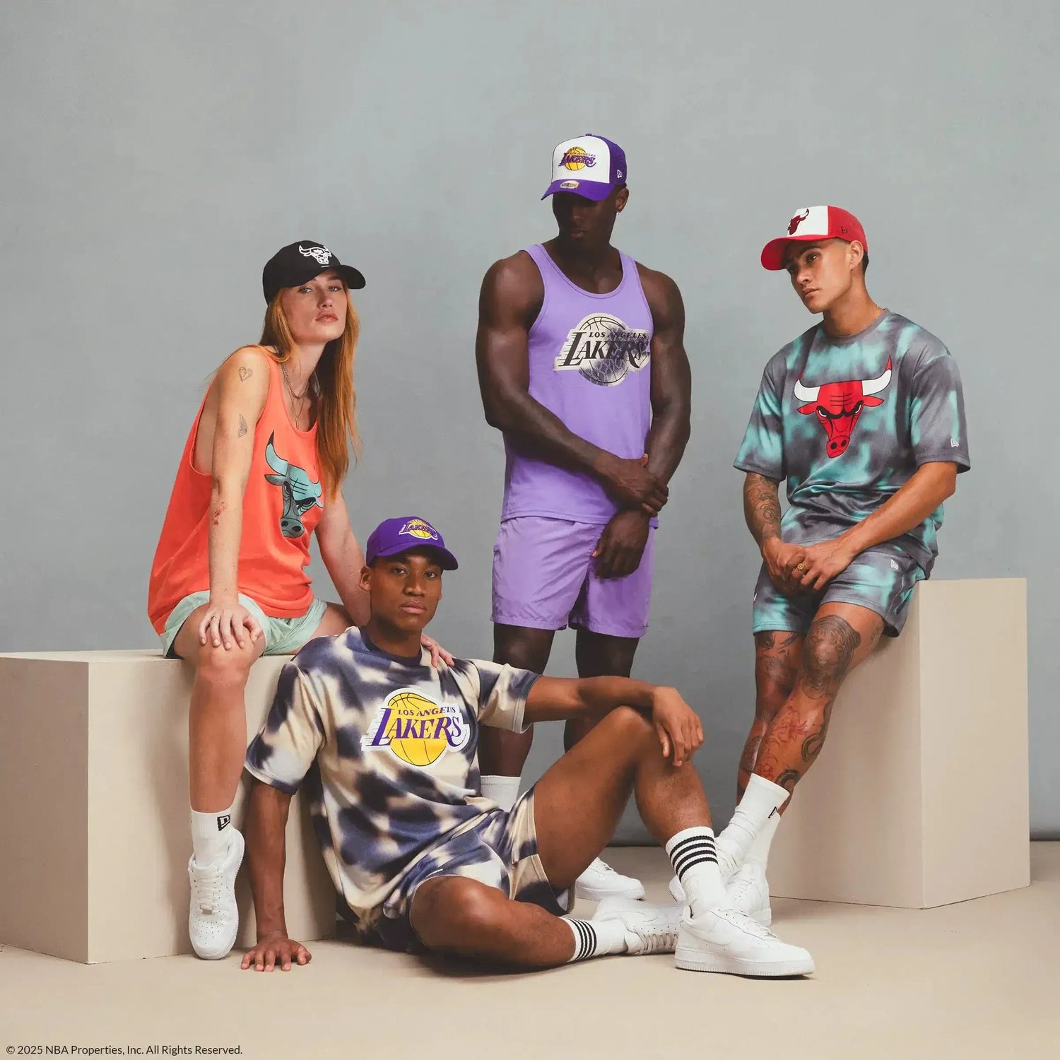 Four people wearing NBA clothing and accessories on a grey background