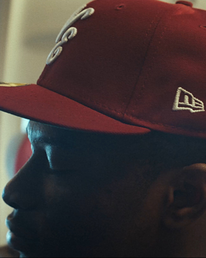 New Era Always On Side model wearing a red pin badge 59FIFTY cap.