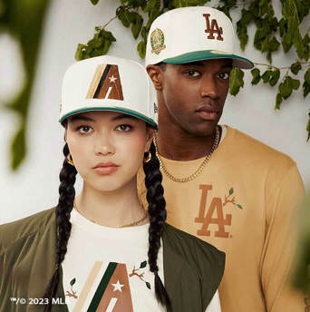 man wearing a white LA dodgers 59fifty cap with a green visor and a woman wearing a white Arizona diamondbacks 59fifty cap with a green visor
