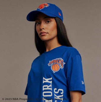 women wearing blue New York knicks t shirt and baseball cap