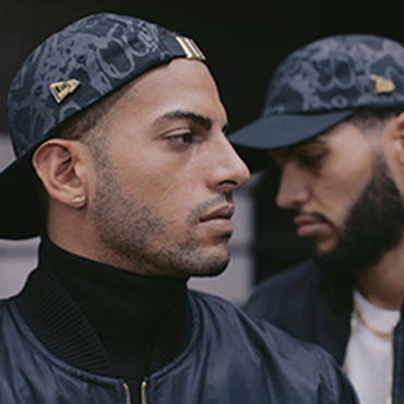 Martinez brothers wearing black and grey new era caps